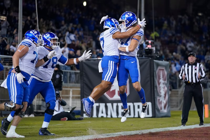 BYU running back Hinckley Ropati (7) celebrates with wide receiver Chase Roberts, right, after a 43-yard touchdown against Stanford in Stanford, Calif., Saturday, Nov. 26, 2022.