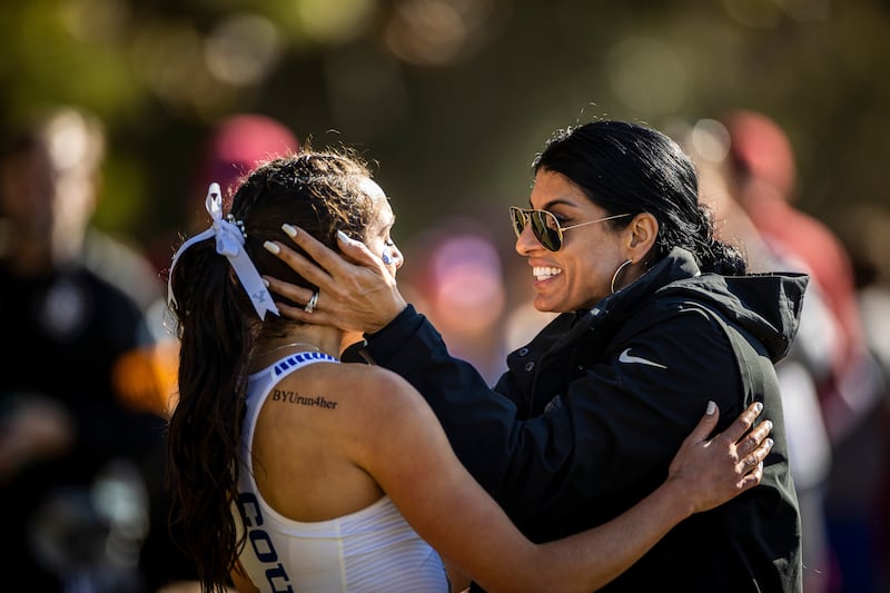 Whittni Morgan is congratulated by BYU coach Diljeet Taylor after winning the NCAA cross-country championship Nov. 20, 2021, in Tallahassee, Florida.