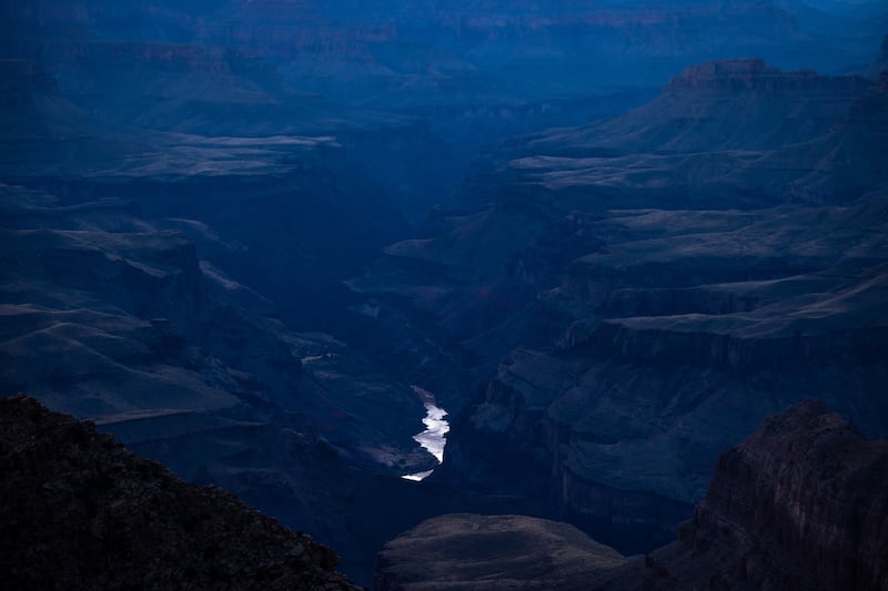 The Colorado River is visible flowing through the Grand Canyon as seen from the south rim of Grand Canyon National Park.