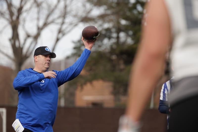 BYU tight ends coach Kevin Gilbride throws a pass during the first day of spring football Feb. 29, 2024.