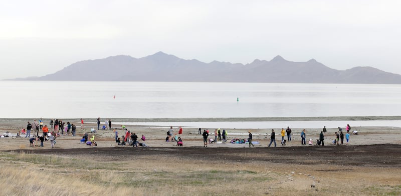 People gather along the shore of the Great Salt Lake.